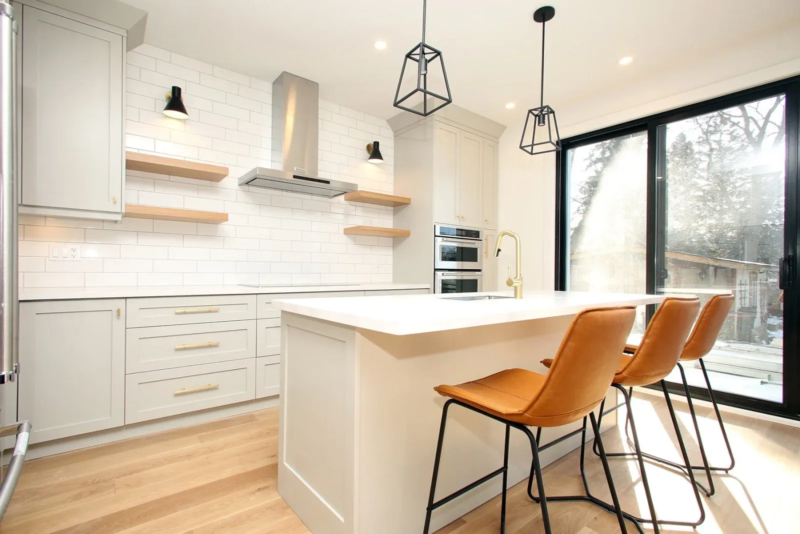 Kitchen with a large island inside a completed Toronto home addition