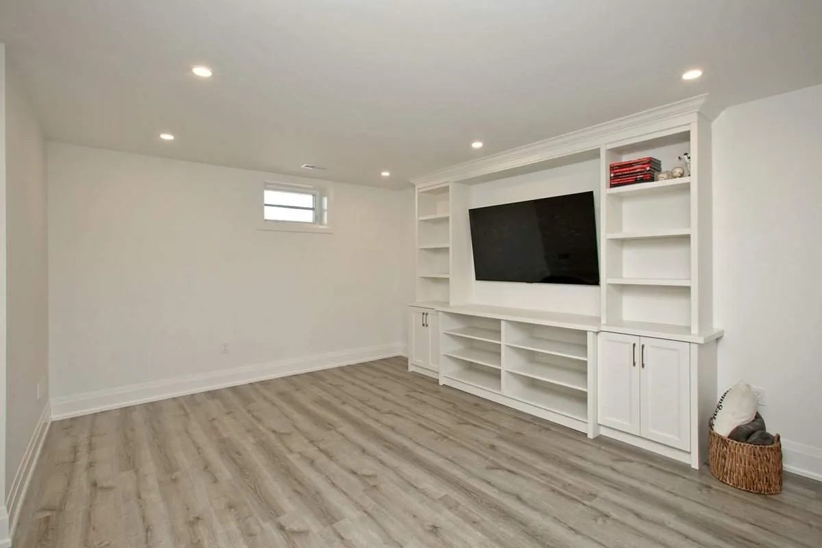 Basement apartment living room with a built-in media wall, finished by Waterfront Home Improvements in Toronto