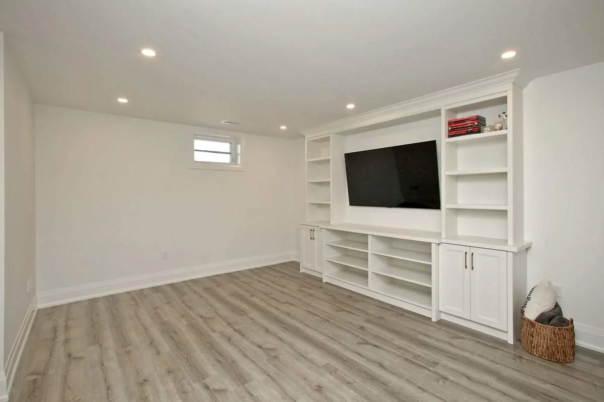 Basement apartment living room with a built-in media wall, finished by Waterfront Home Improvements in Toronto