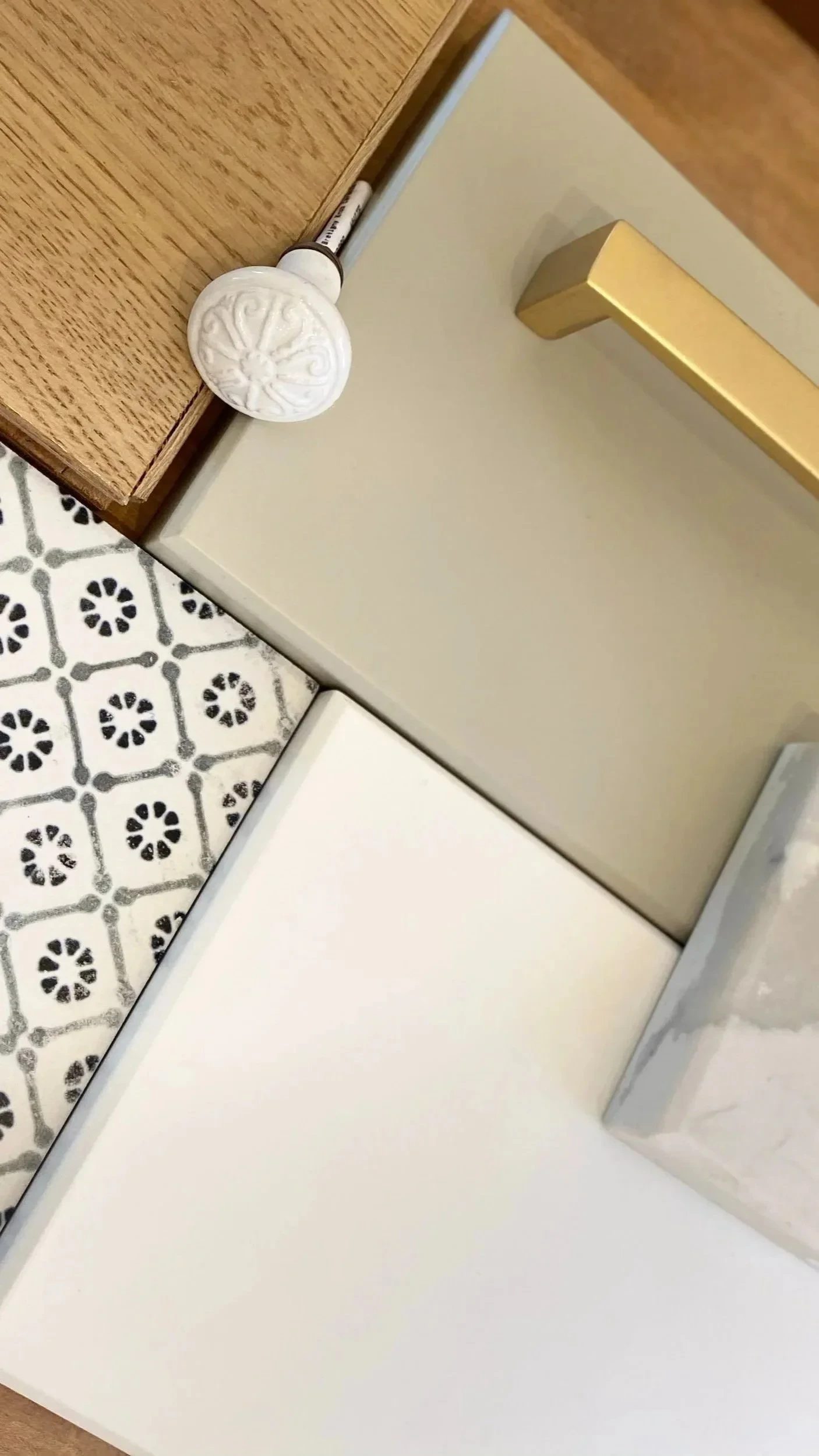 Interior finish selections with patterned tile, brass hardware, stone, and mirrored glass samples.