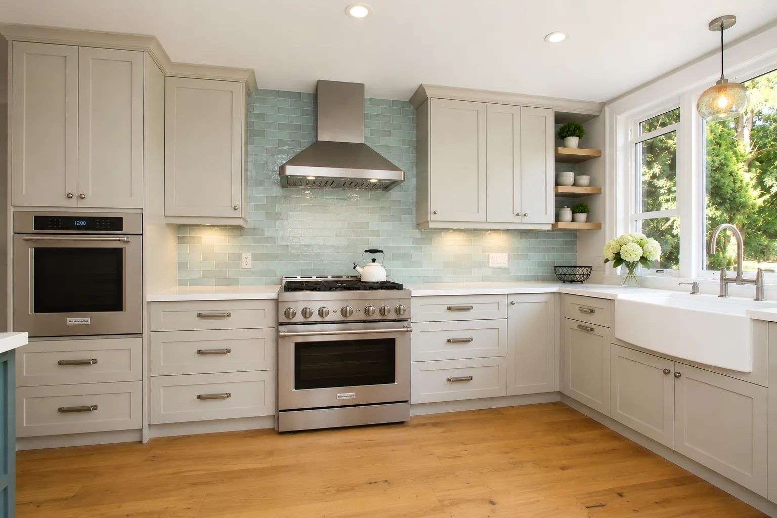 Light blue kitchen cabinetry with warm wood accents in a finished renovation.