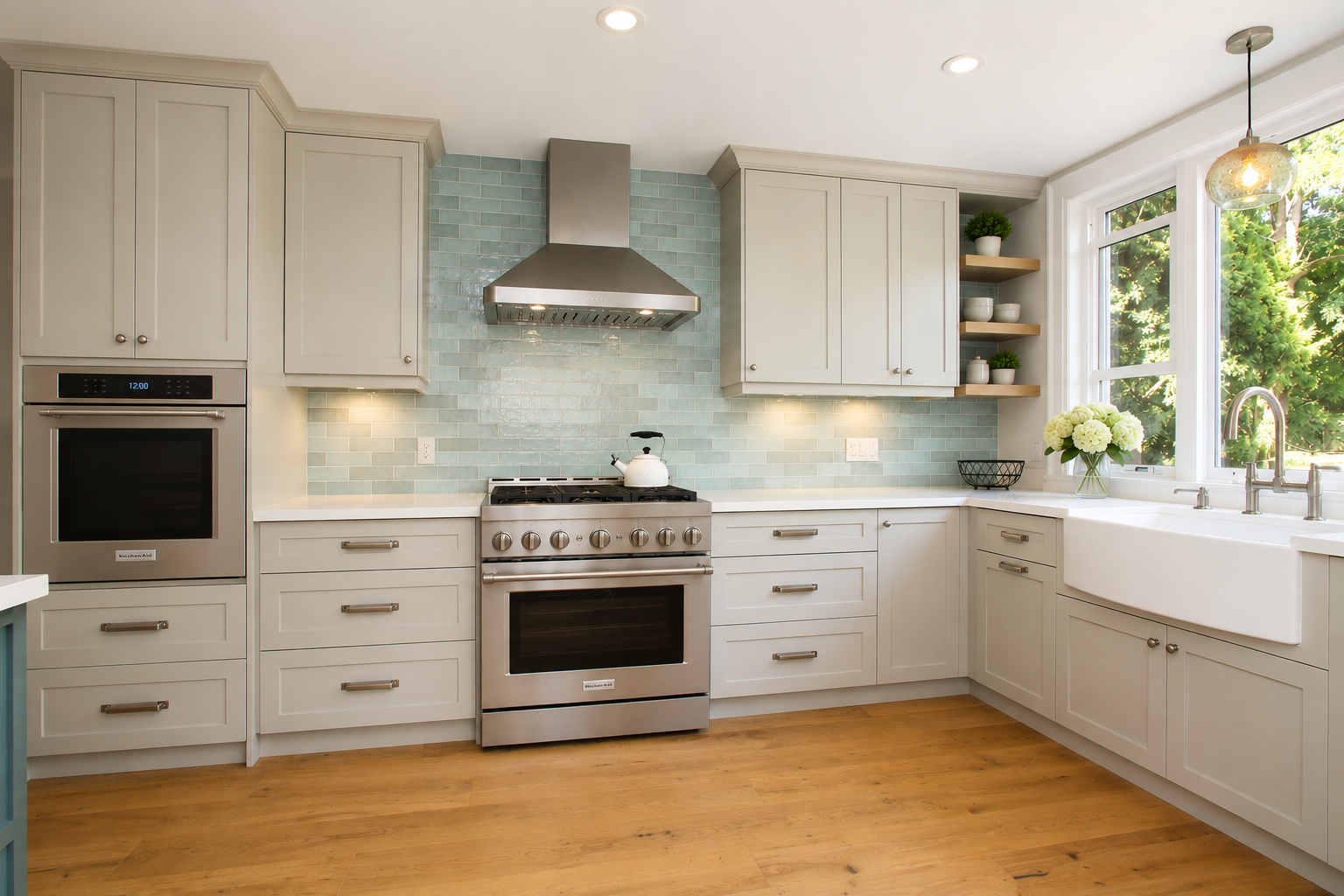 Light blue kitchen cabinetry with warm wood accents in a finished renovation.