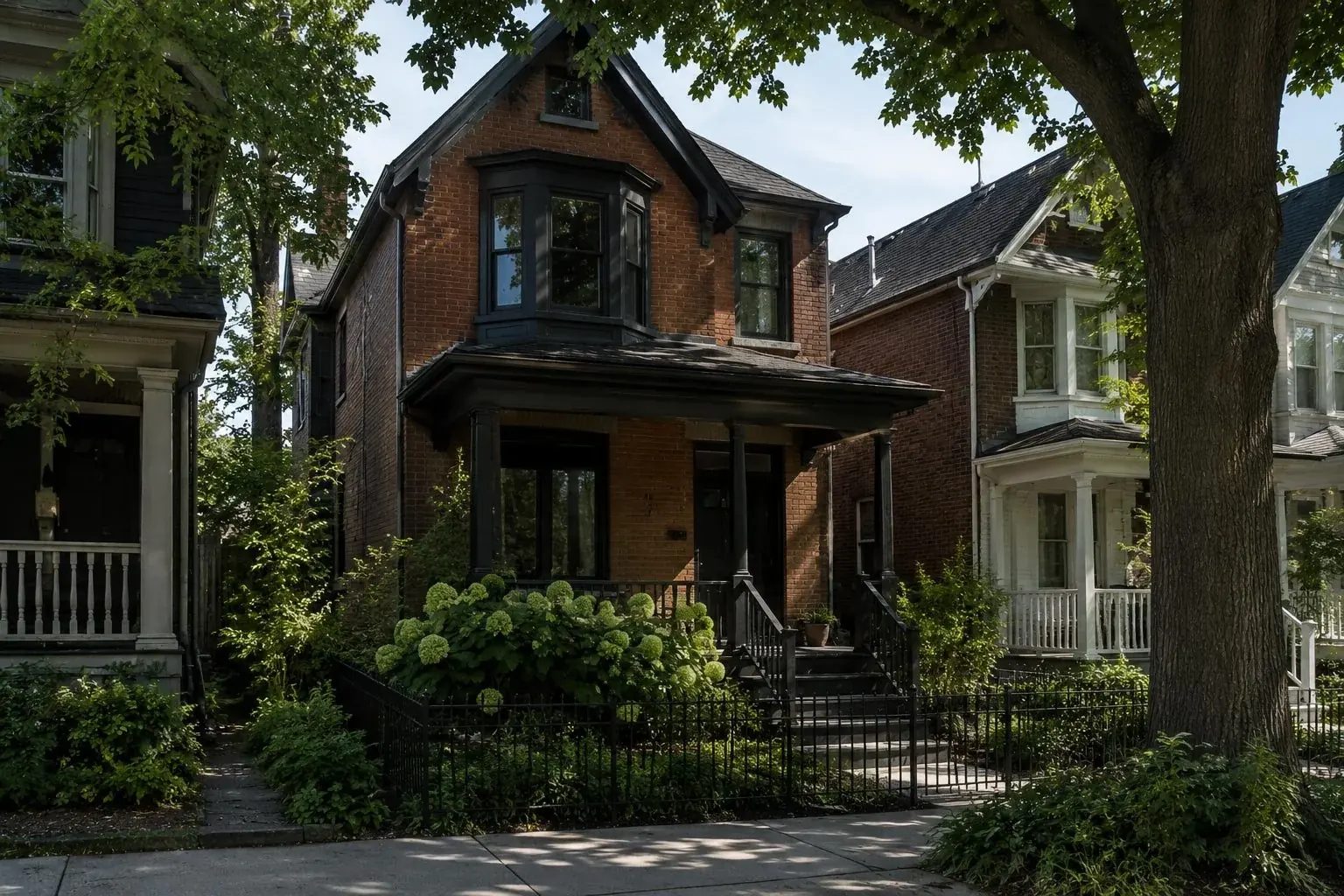 Century home exterior with original brick and trim detailing in Roncesvalles, Toronto.