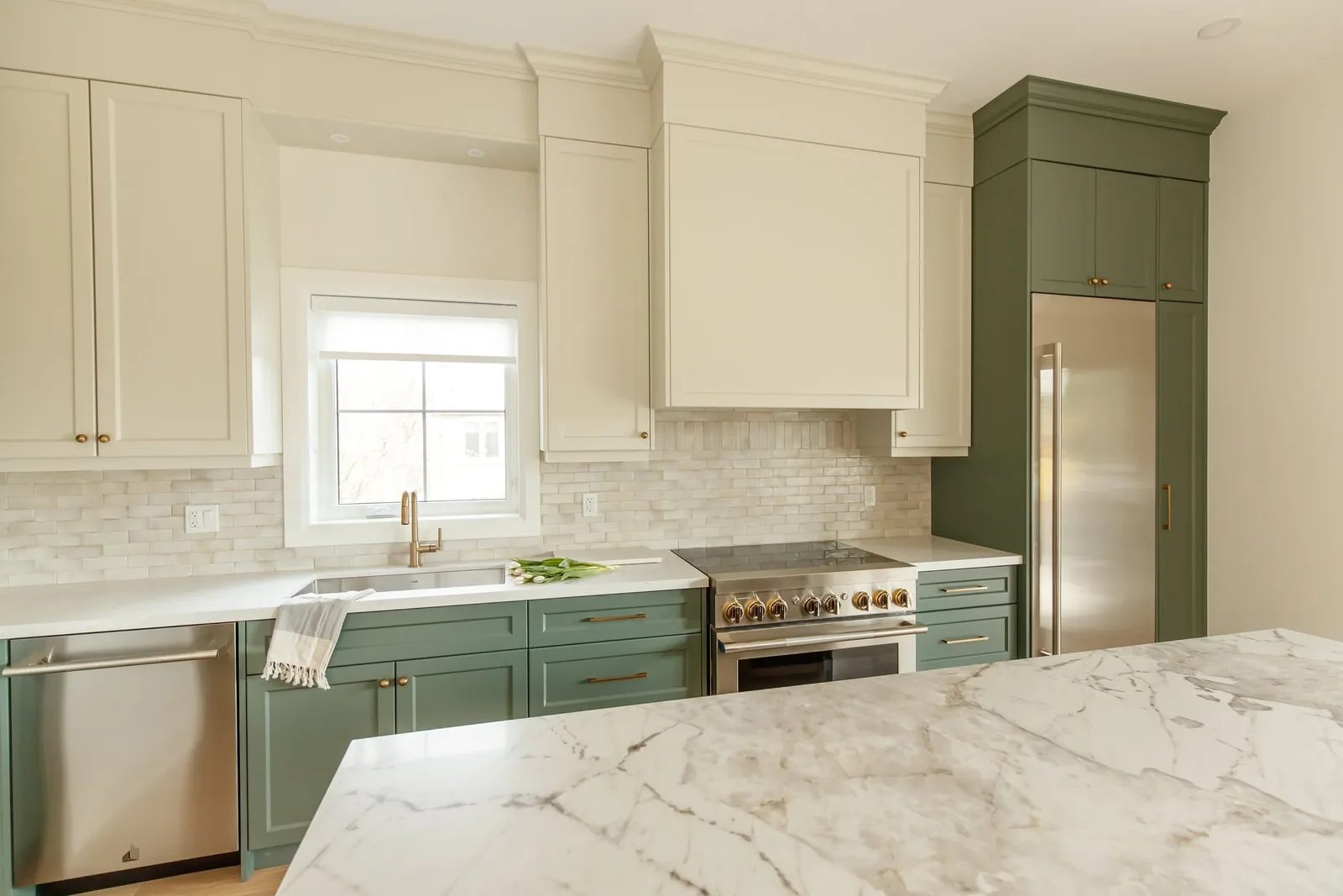 Angled kitchen view showing cream uppers