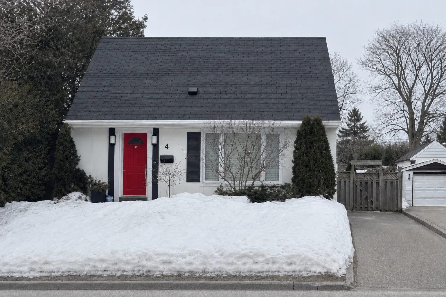 Winter street view of the original one-storey house before the second-storey addition, Peace Restored project.