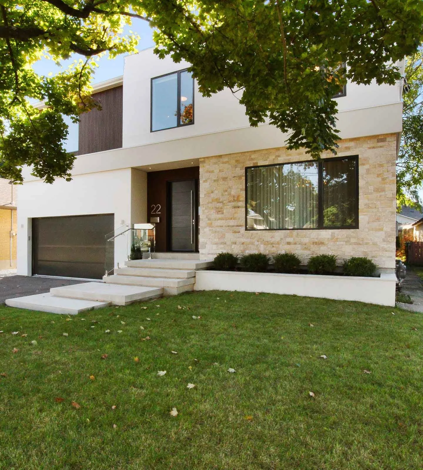 A Spanish style home with a light stone exterior, designed by Waterfront, a design-build firm