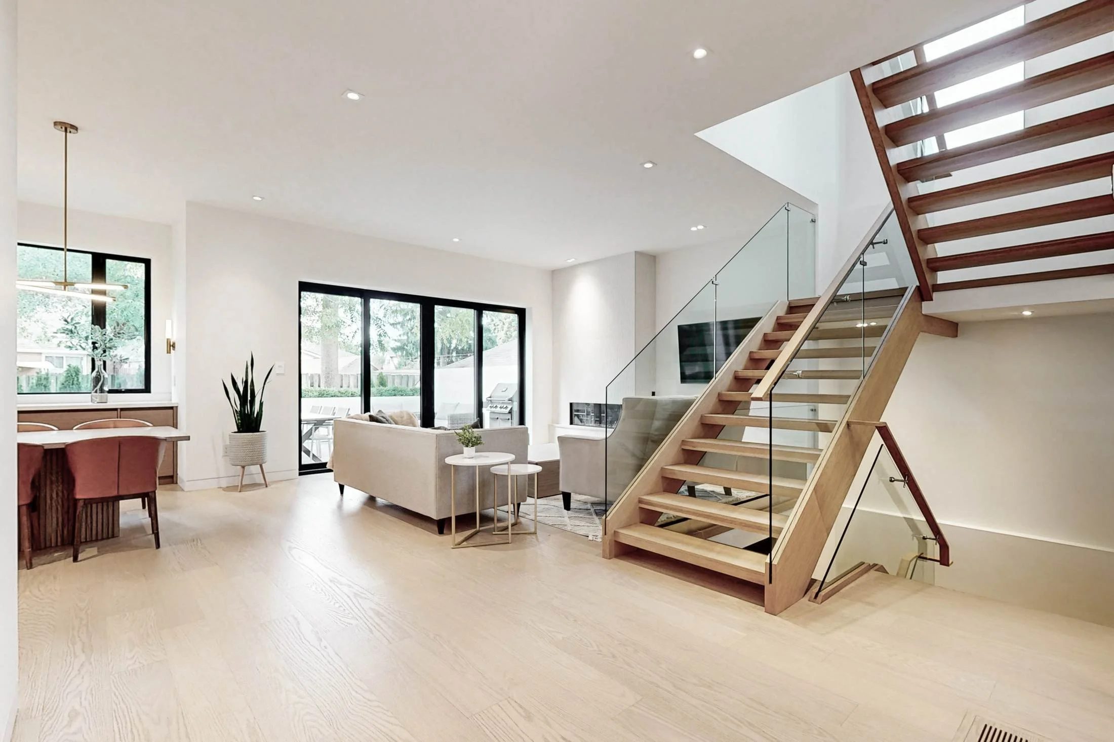 After renovation, open-concept main floor with floating staircase in Etobicoke.