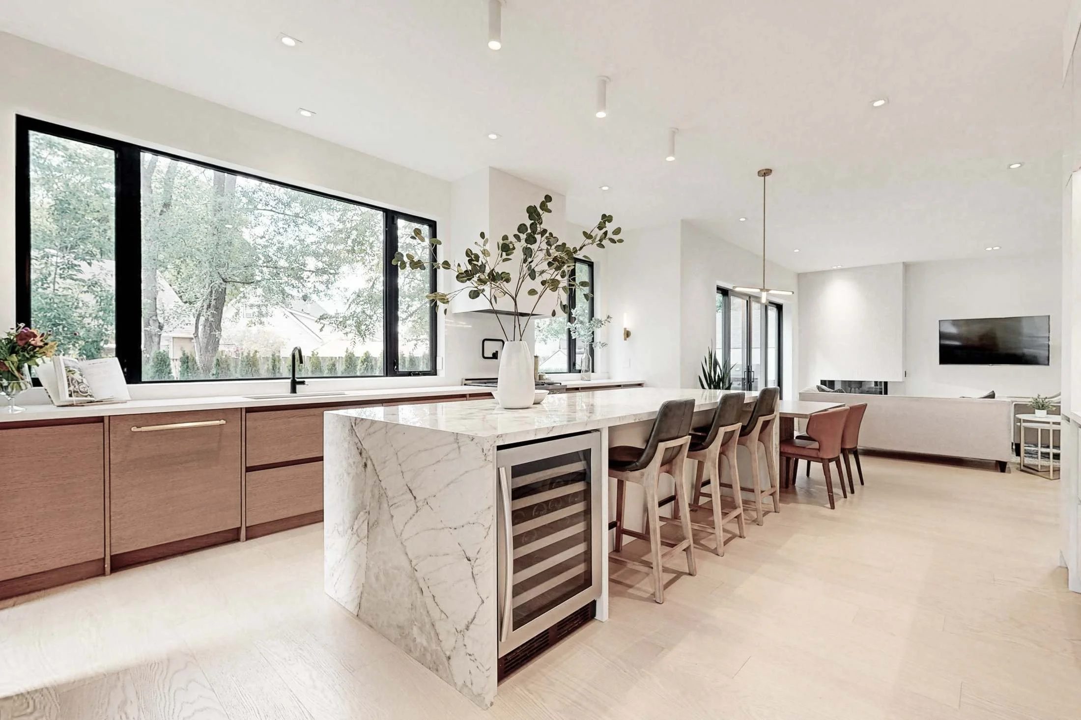 Secondary prep counter in matte white with a black faucet and bar sink looks toward the dining area.