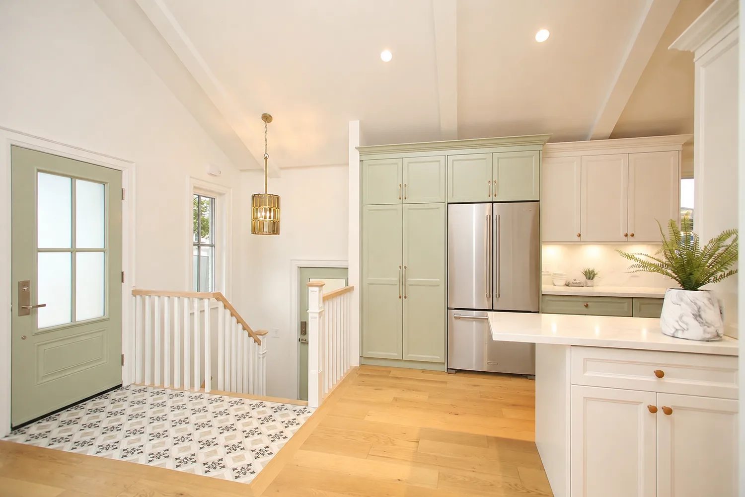 Entry foyer and staircase with custom detailing in an Etobicoke interior reconfiguration.
