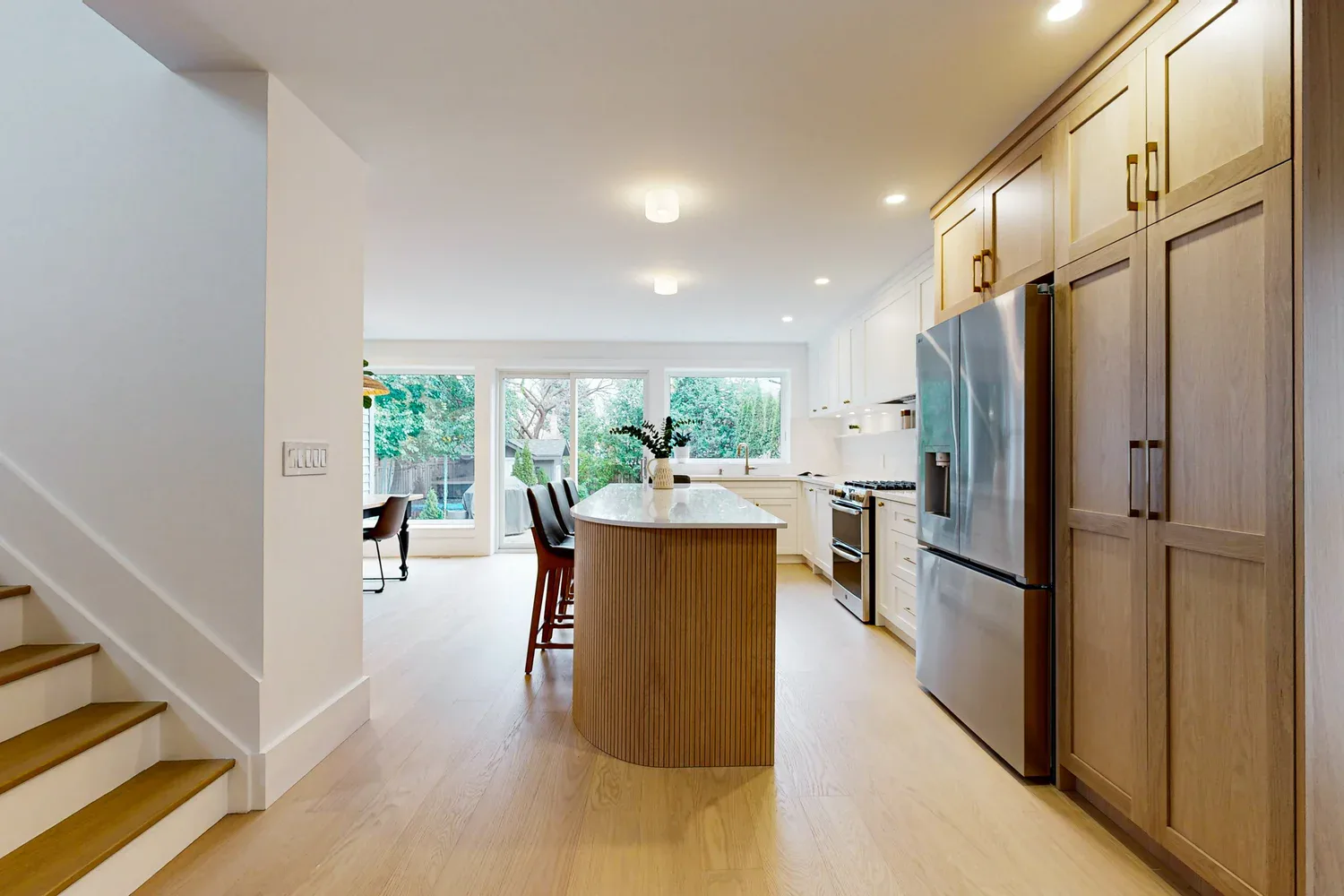 Open main floor after an Etobicoke interior reconfiguration and wall removal.